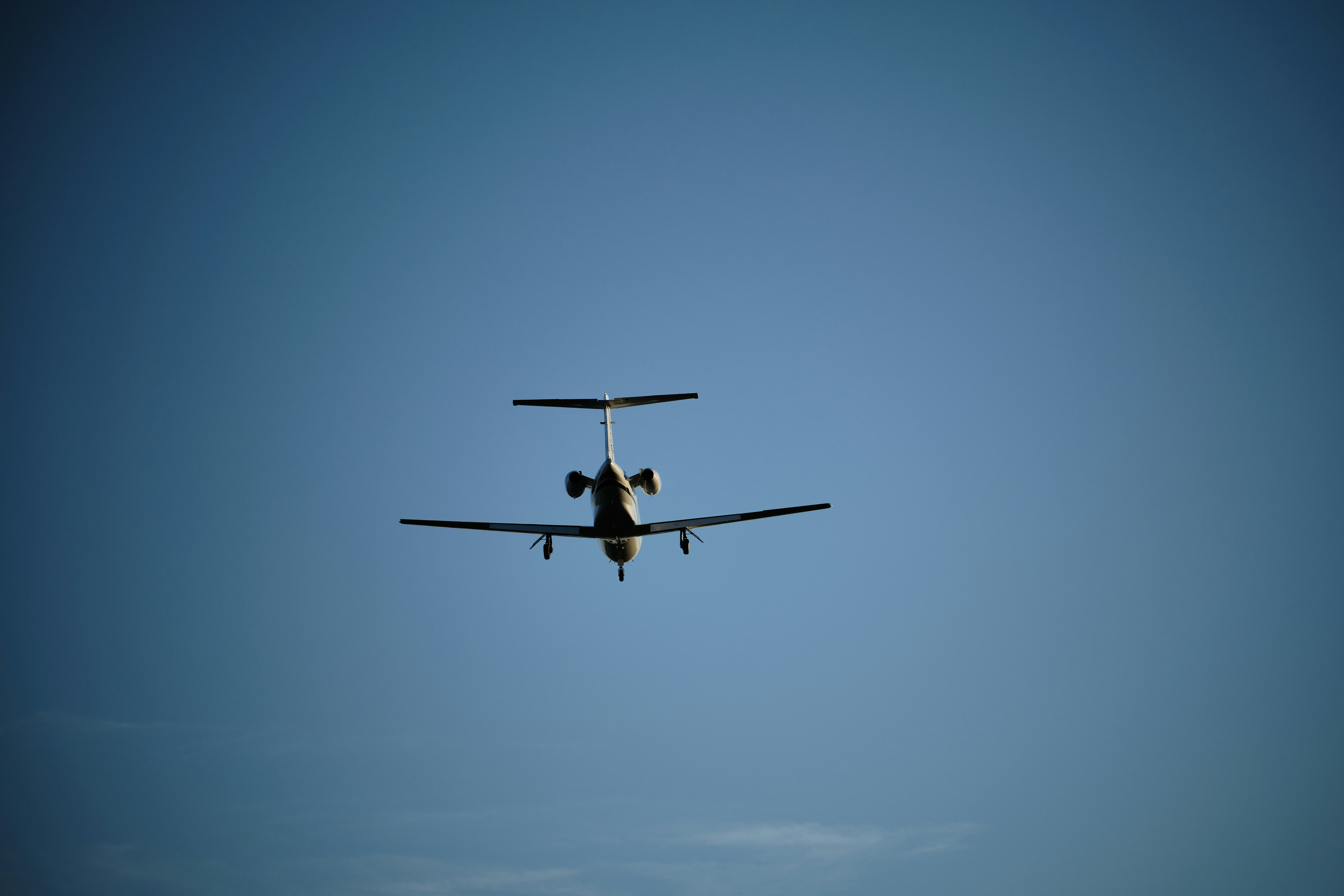 an airplane is flying in the blue sky